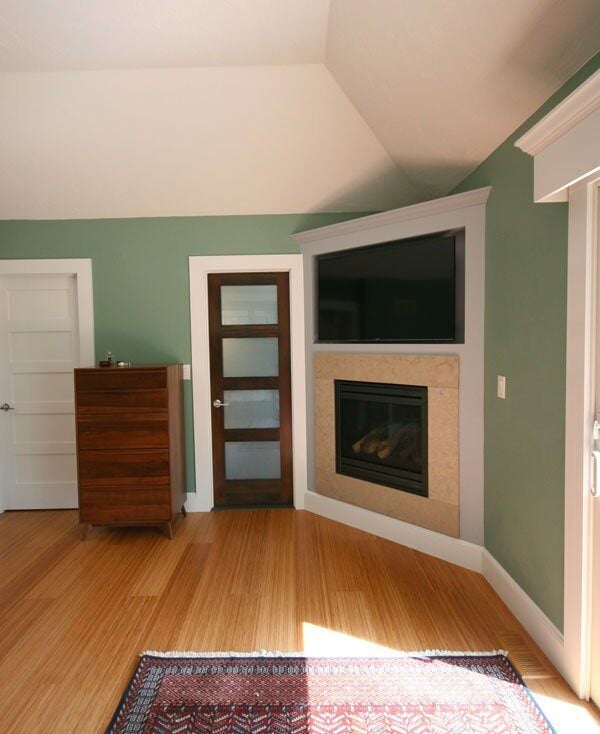 Sage green living room with a modern fireplace and wooden accents in Sandwich home