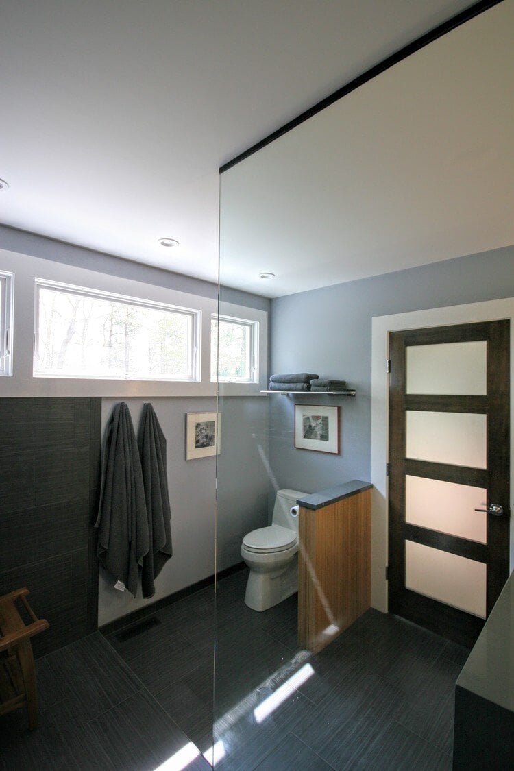 Spacious Mashpee bathroom remodel with dark tiles and large windows