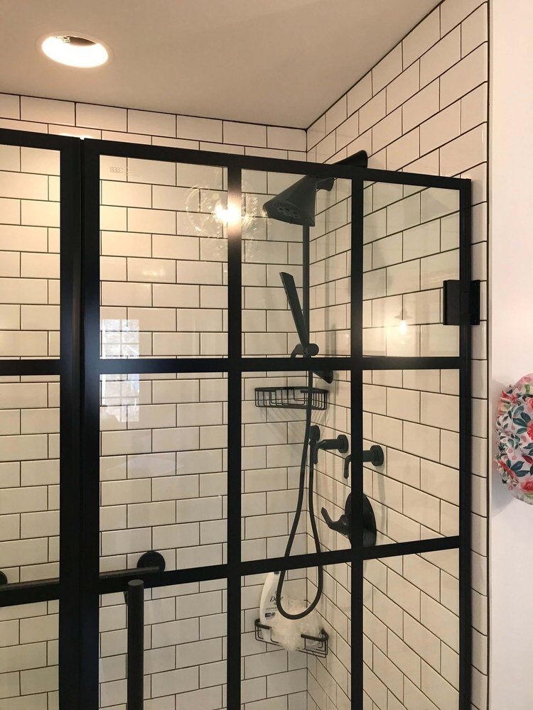 Detailed view of modern shower enclosure with black metal frame, Bay Road Bath remodel by At Design Remodel in North Falmouth, Mashpee