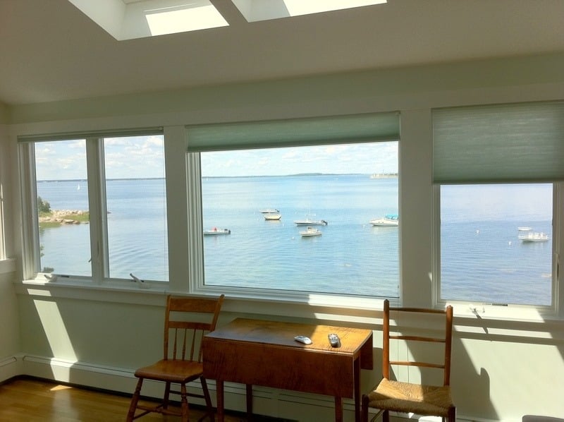 Coastal-themed bedroom with water views and window installation by At Design Remodel in Cataumet, MA