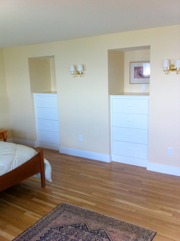Custom built-in bedroom storage units in a Cataumet home remodel by At Design Remodel