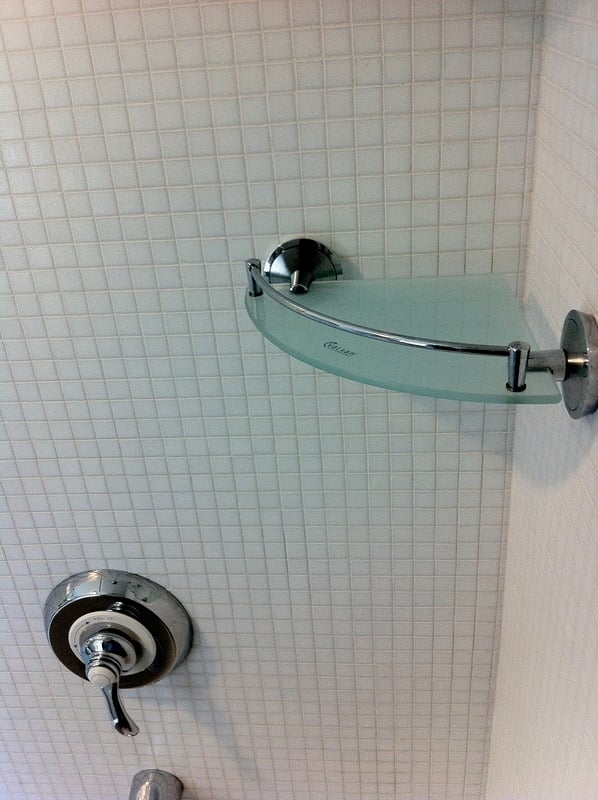 Modern shower fixture with glass shelf installed in a bathroom renovation by At Design Remodel in Cataumet