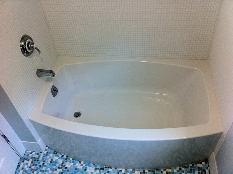 Newly installed bathtub with chrome hardware during a bathroom renovation in Cataumet by At Design Remodel