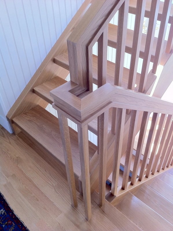 Newly installed wooden staircase in a custom home remodel by At Design Remodel, Cataumet