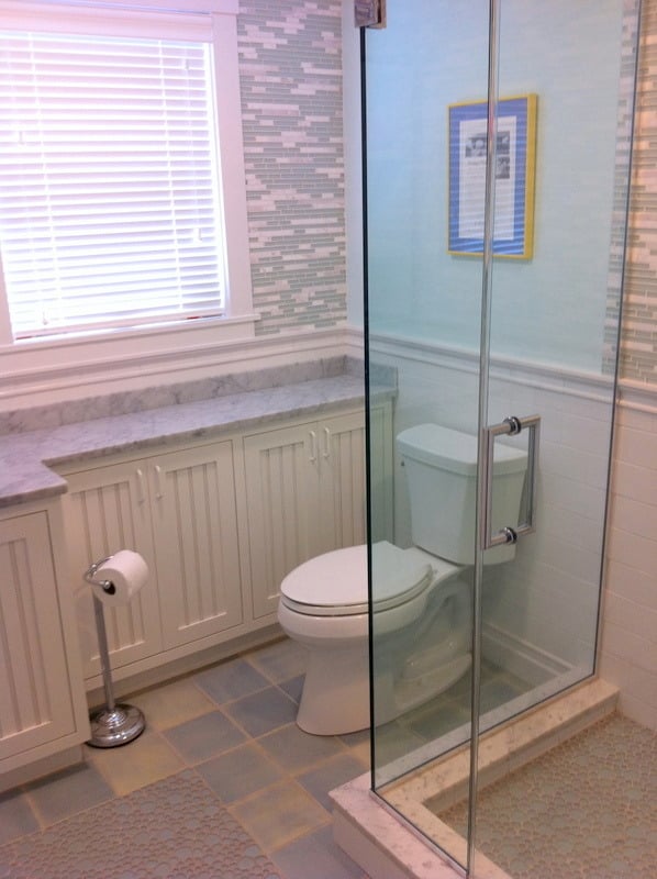 Shower area with chrome fixtures and glass shelf from a bath remodel by At Design Remodel in Cataumet, Mashpee