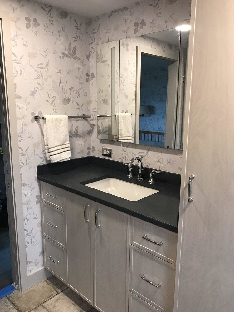 Modern bathroom vanity with ample storage and mirror in Centerville, remodeled by At Design Remodel in Mashpee