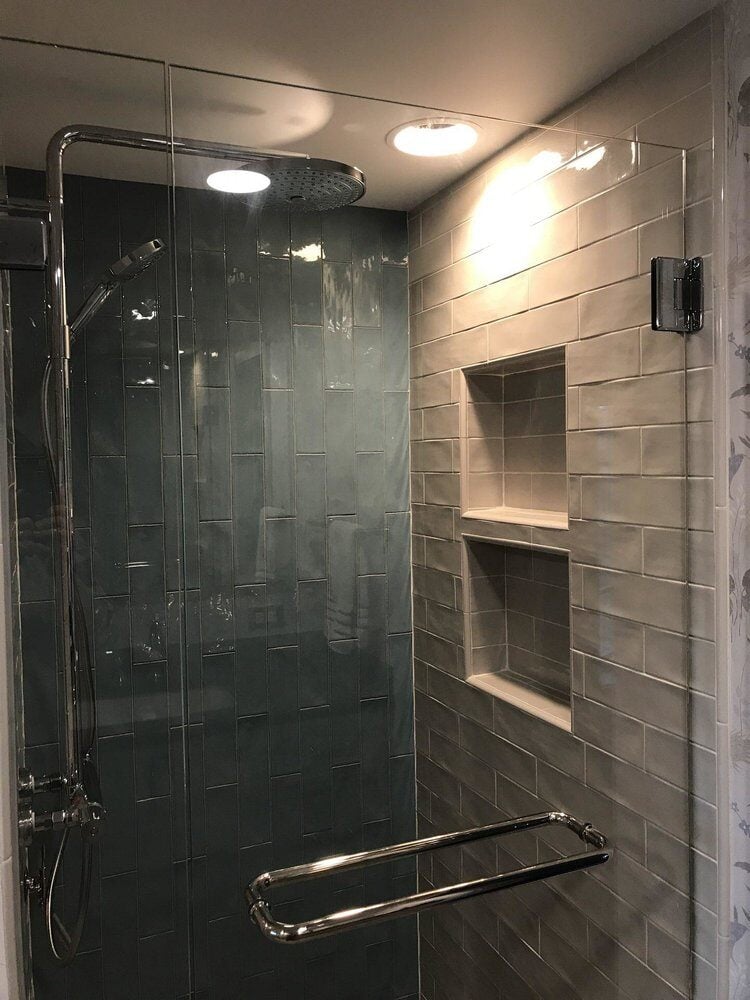 Modern tiled shower with glass door in Centerville bathroom remodel by At Design Remodel in Mashpee