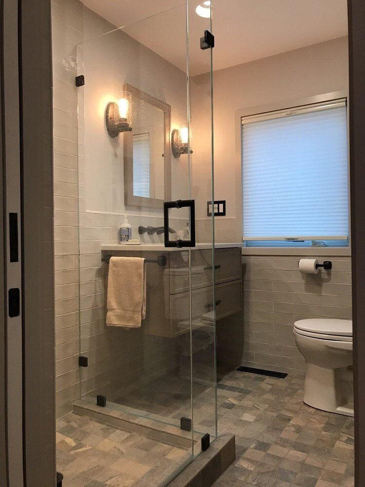 Modern bathroom renovation in Centerville featuring glass shower and stylish lighting by At Design Remodel, Mashpee