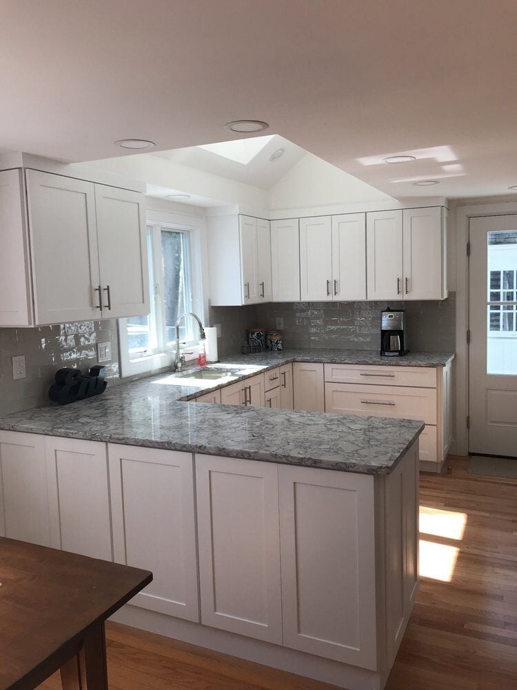 Light-filled kitchen with white cabinets and granite countertops, Centerville Kitchen Remodel by At Design Remodel, Mashpee