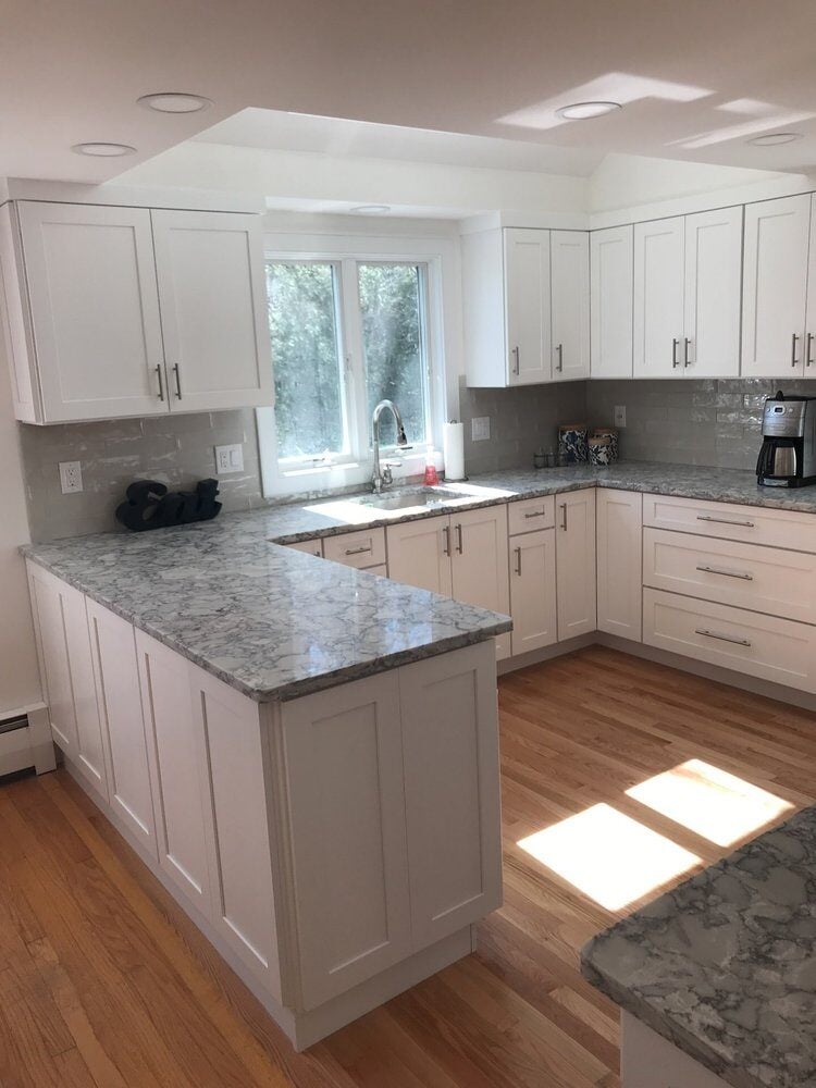 Modern kitchen with white cabinetry and a large stainless steel fridge, Centerville Kitchen Remodel by At Design Remodel, Mashpee