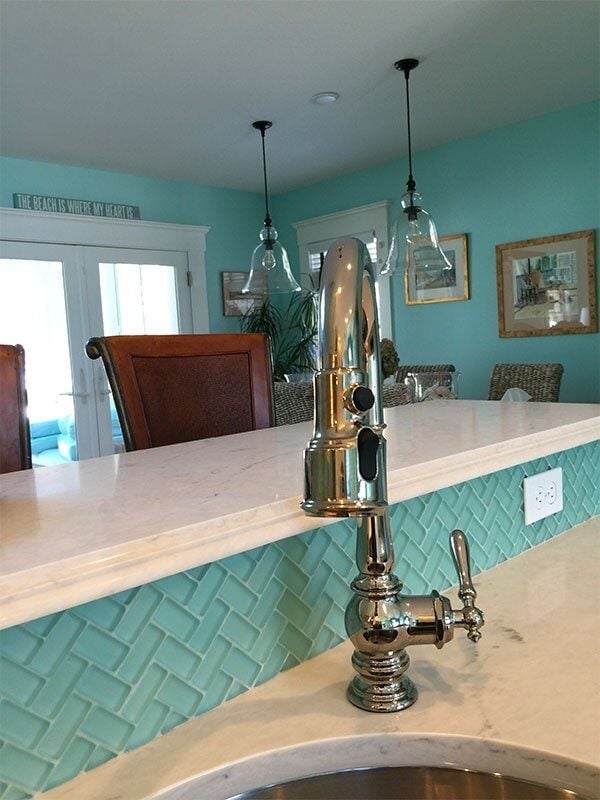 Bright kitchen remodel with white cabinetry and turquoise accents in Cotuit by At Design Remodel