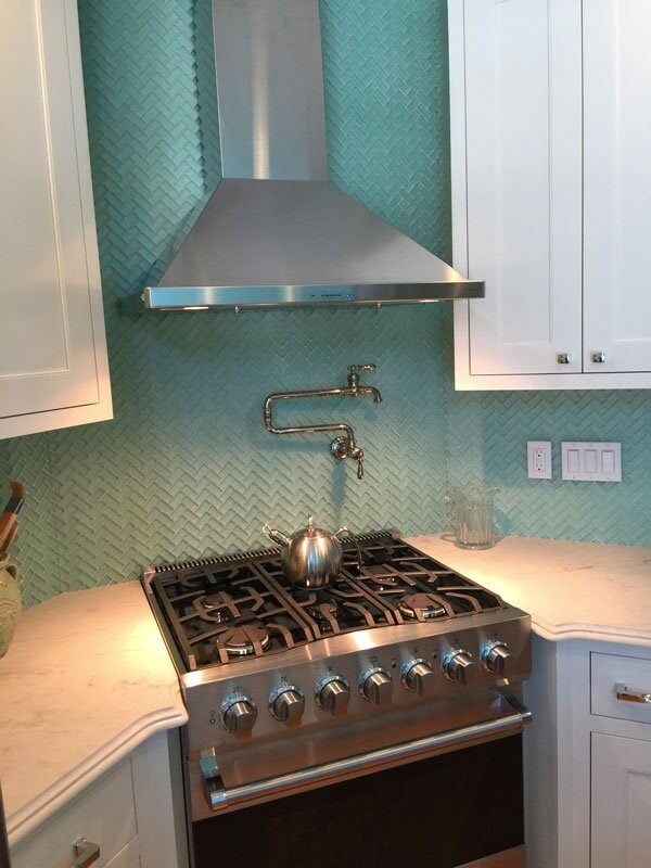 Turquoise backsplash with a herringbone pattern in a remodeled kitchen in Mashpee by At Design Remodel