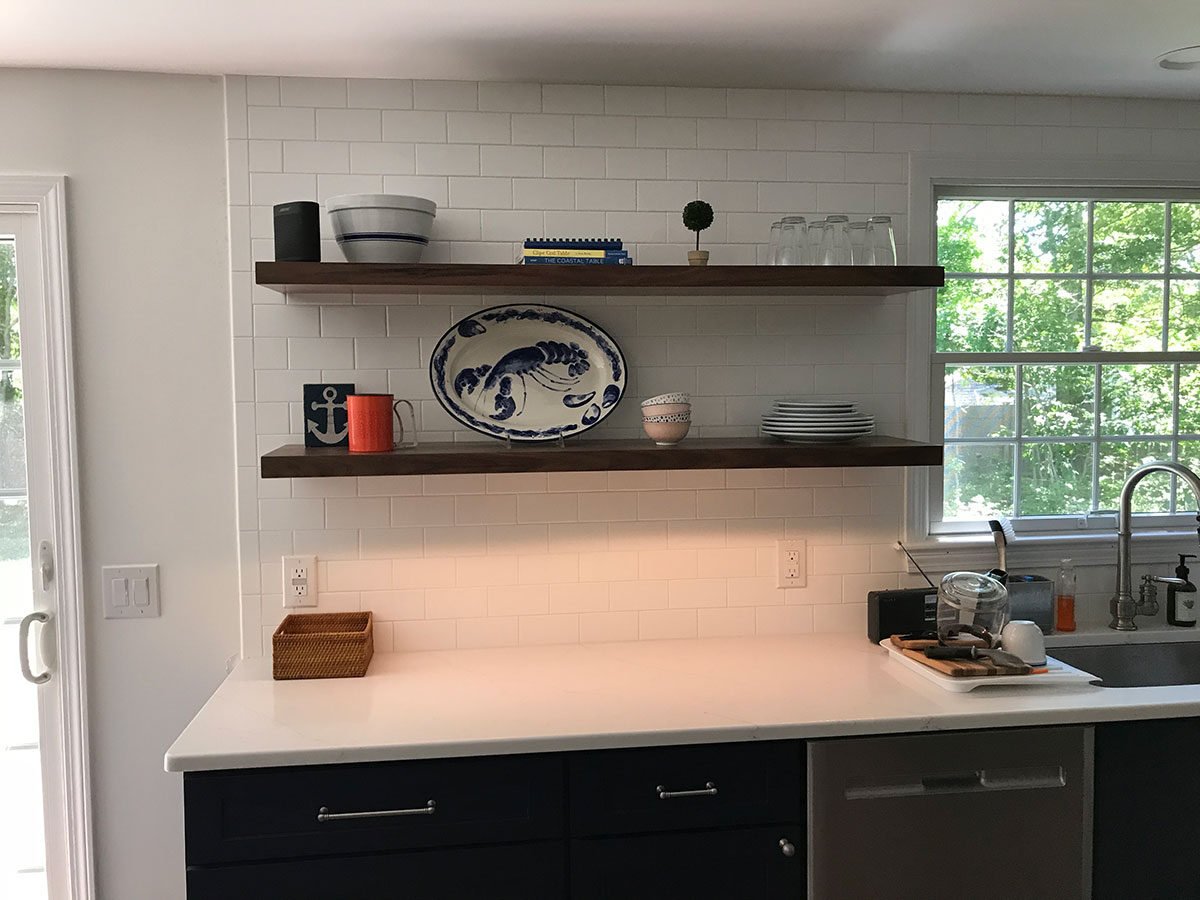 Coastal-inspired kitchen with floating shelves and bright backsplash, remodel project by At Design Remodel, Mashpee