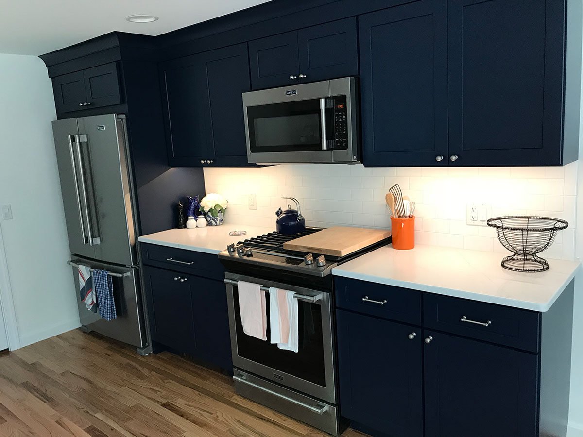 Renovated kitchen featuring navy cabinetry and bright white countertops, At Design Remodel, Mashpee