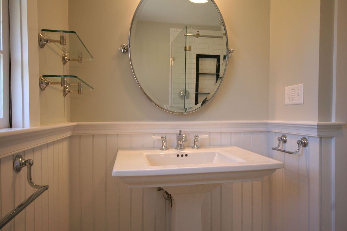 Bathroom vanity with glass shelving and modern fixtures in Pin Oak Bath renovation, Mashpee