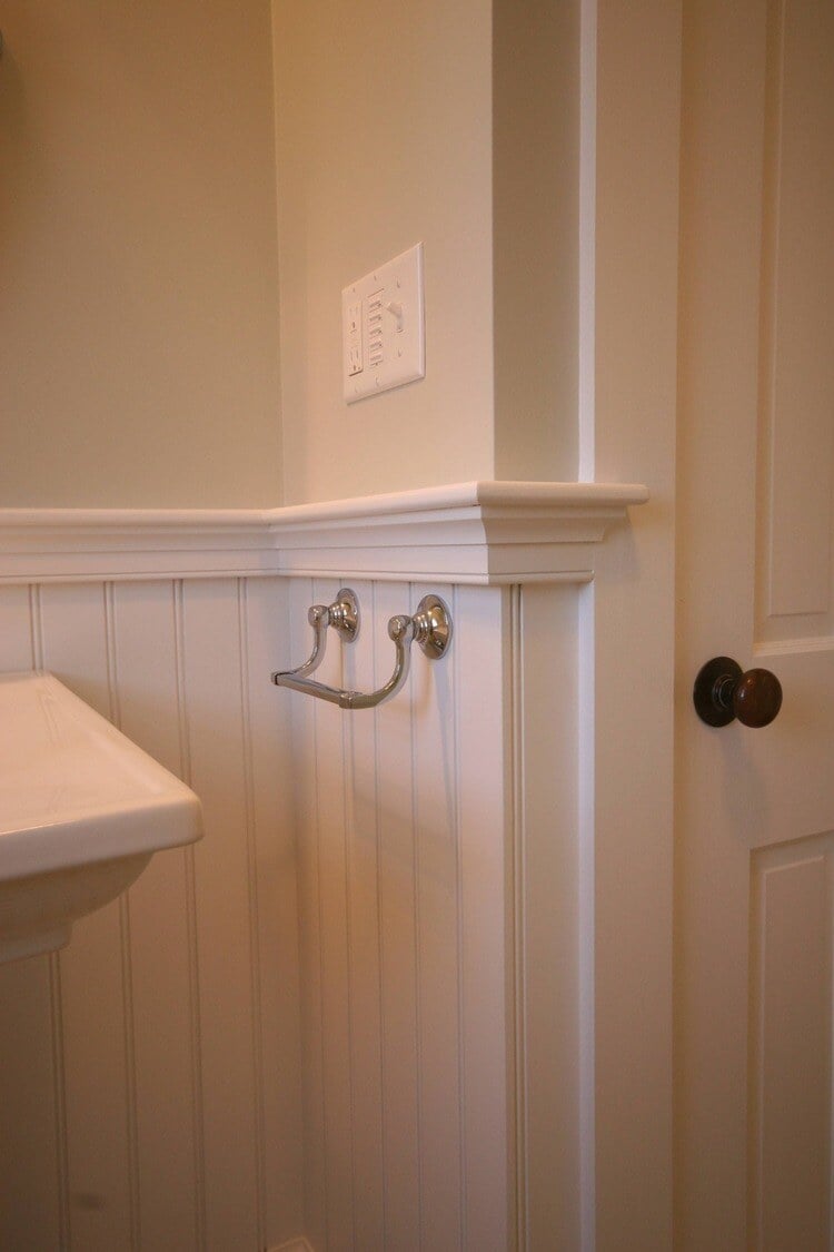 Remodeled bathroom wall paneling and towel holder installation at Pin Oak Bath by At Design Remodel, Mashpee