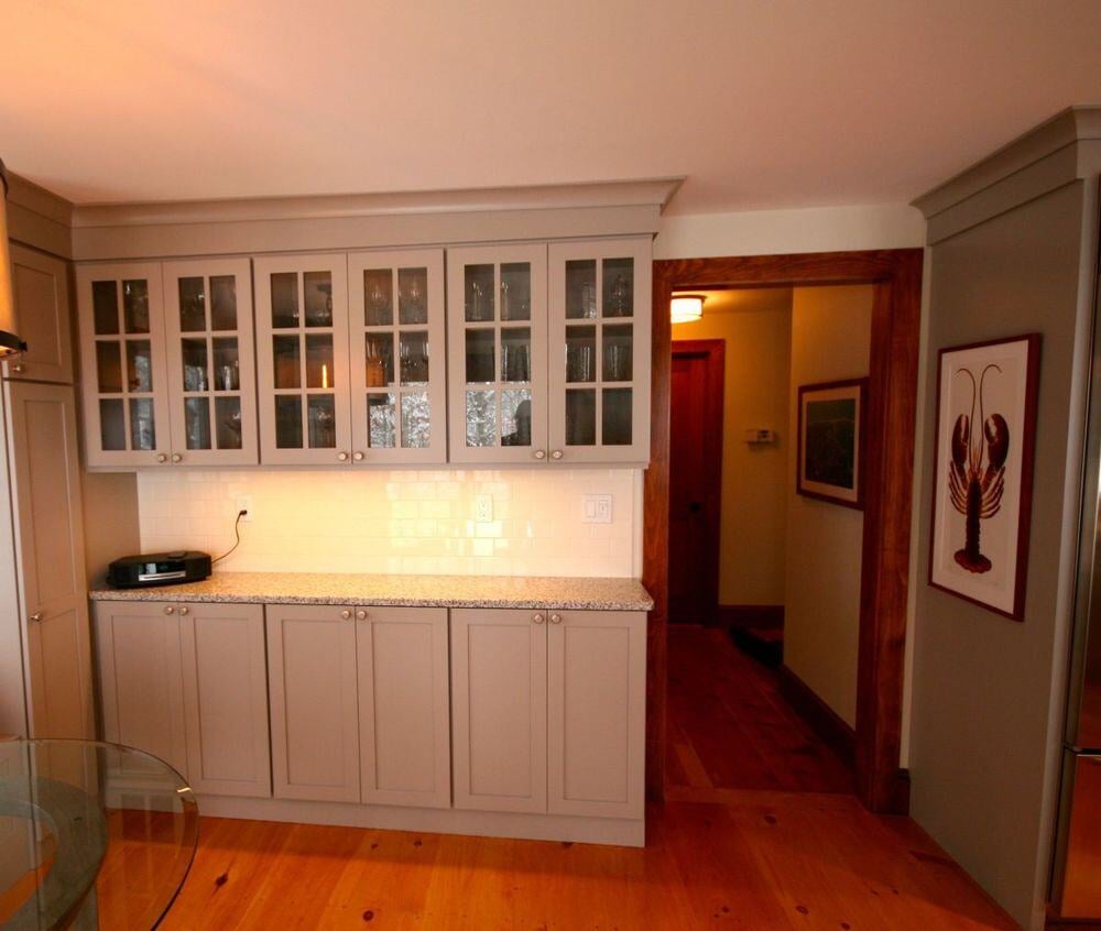 Custom kitchen cabinetry with glass doors in a Falmouth home renovation by At Design Remodel