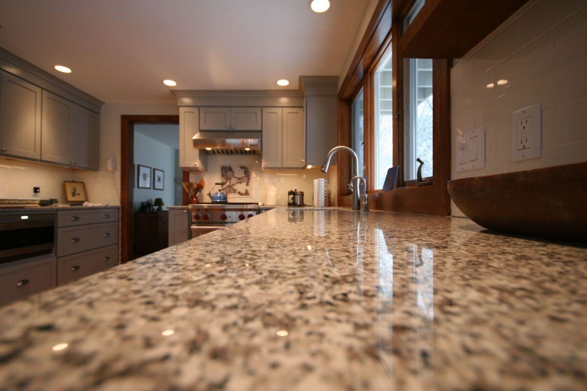 Granite countertop with a view of the kitchen stove in a Falmouth kitchen remodel by At Design Remodel