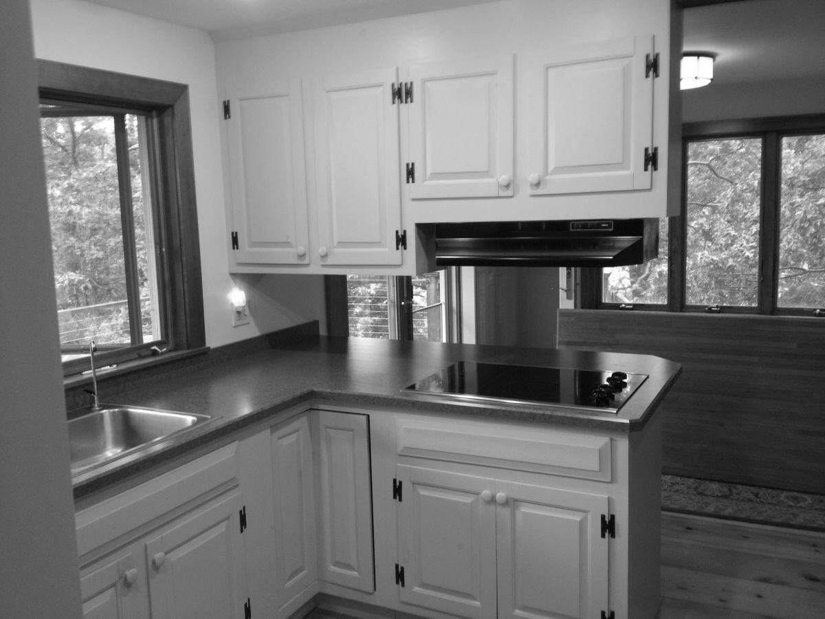 Pre-renovation kitchen with white cabinets in a Falmouth home