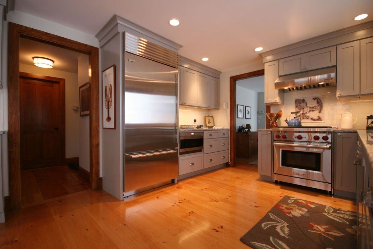 Sleek custom kitchen renovation in Falmouth featuring gray cabinetry and stainless steel appliances