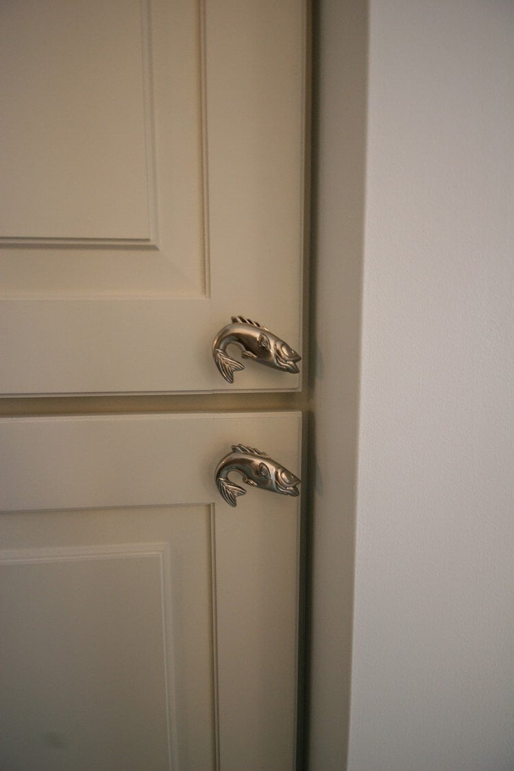 Unique fish-shaped cabinet handles in a Mashpee bathroom remodeled by At Design Remodel