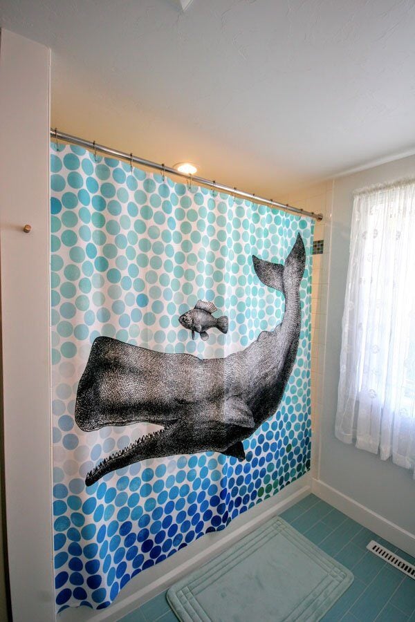 Whale design on a blue polka dot shower curtain, part of a bathroom remodel by At Design Remodel in Mashpee