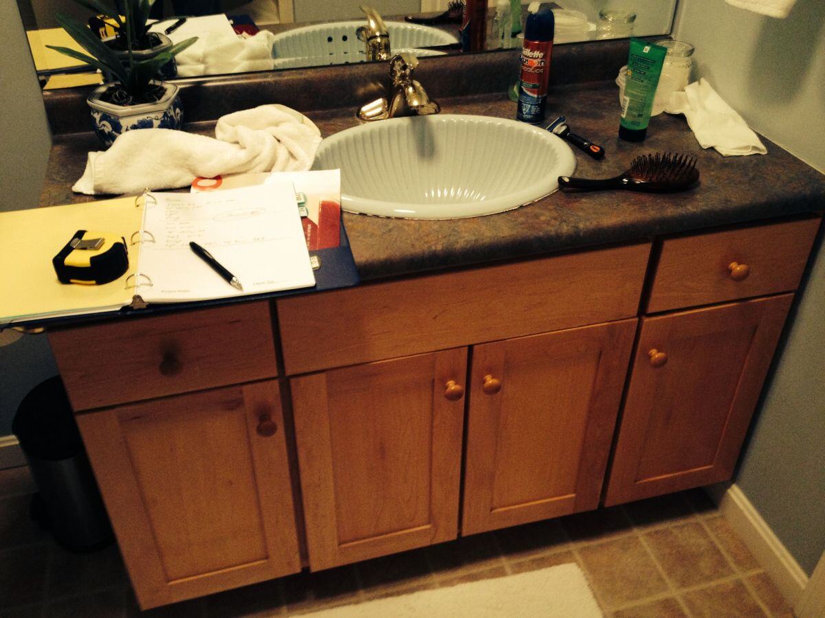 Bathroom vanity with wooden cabinets before Mashpee remodel by At Design Remodel