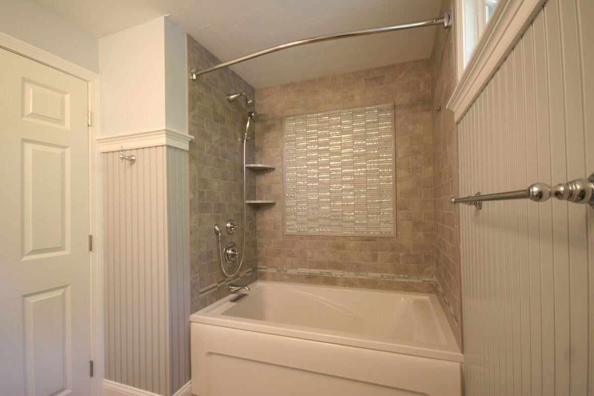 Custom tiled shower with mosaic accent wall in Mashpee bathroom remodel by At Design Remodel