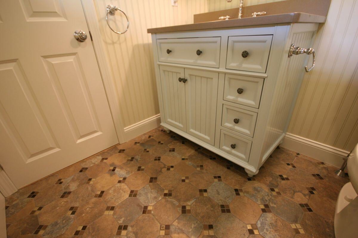 Custom vanity and tile flooring in remodeled Mashpee bathroom by At Design Remodel