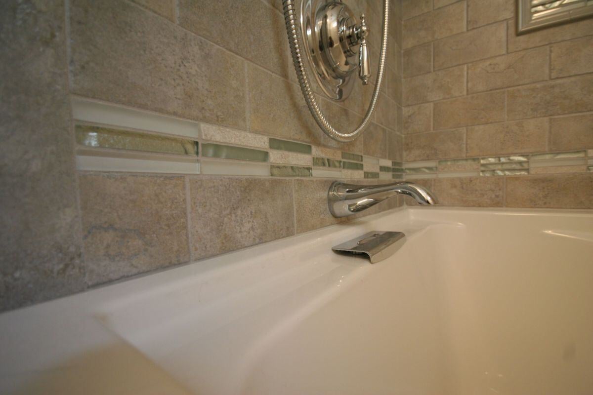 Elegant vanity and mirror in newly remodeled Mashpee bathroom by At Design Remodel