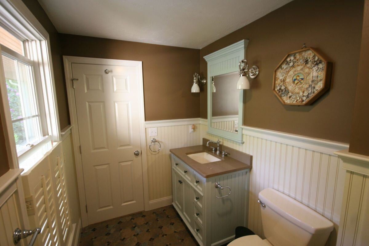 Freshly remodeled bathroom with a sleek vanity in Mashpee by At Design Remodel