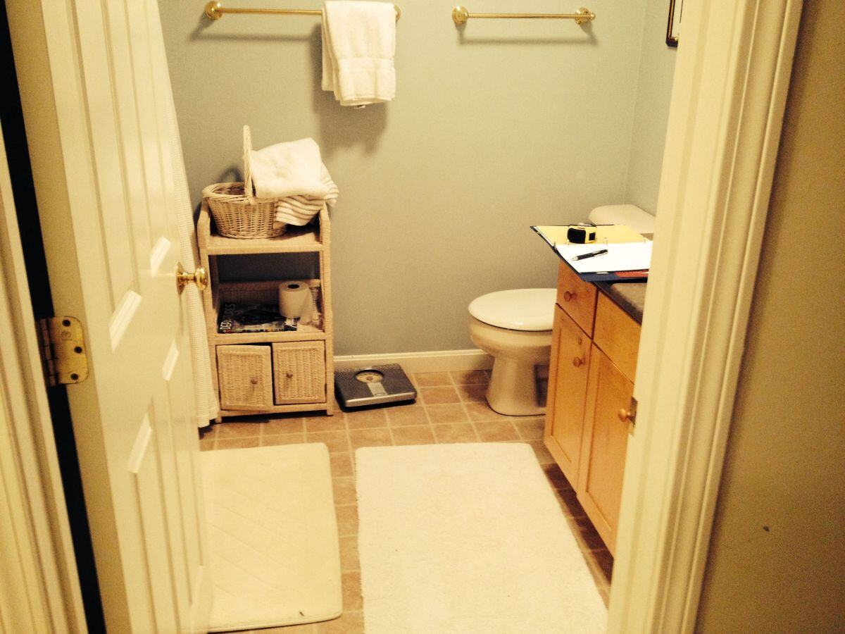 Mashpee bathroom before remodel featuring basic layout and shelving