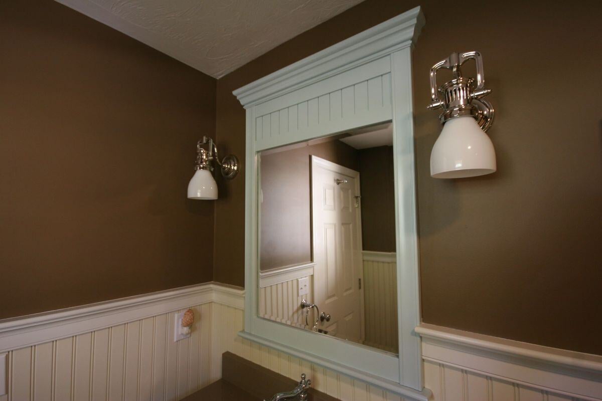 Remodeled bathroom with upgraded lighting and mirror in Mashpee by At Design Remodel