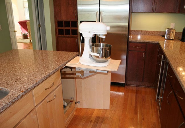 Custom kitchen remodel by At Design Remodel in Mashpee showcasing a retractable mixer stand and granite countertops