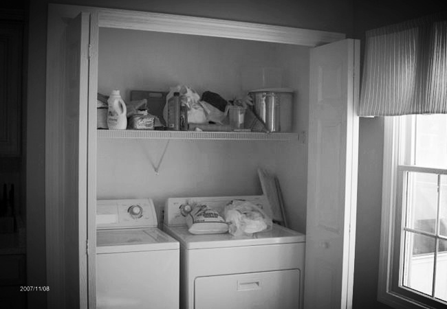 Laundry area in a custom home remodeling project by At Design Remodel in Mashpee, featuring a compact washer and dryer setup