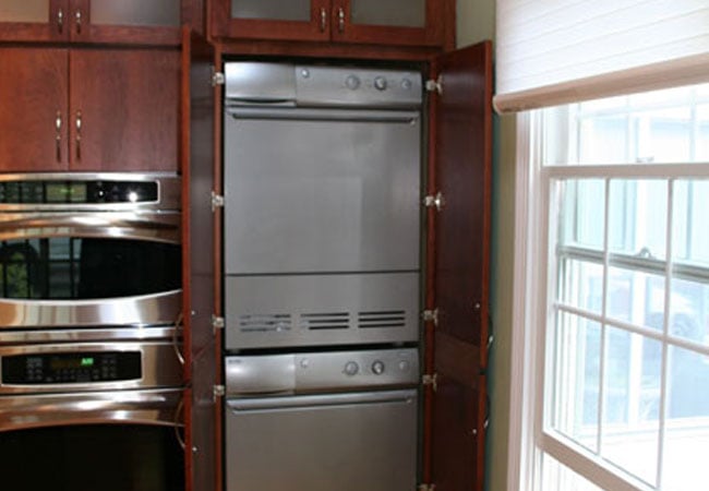 Pull-out pantry drawers in a custom kitchen remodel by At Design Remodel in Mashpee