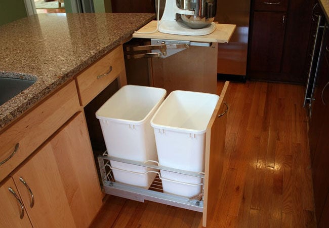 Pull-out trash bin integrated into a Mashpee kitchen remodel by At Design Remodel