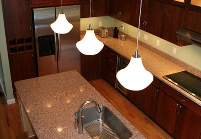 Stainless steel fridge and dark wood cabinets in a Mashpee kitchen renovation by At Design Remodel