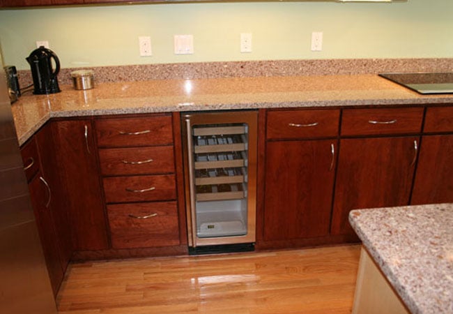 Wine cooler built into cabinetry in a Mashpee kitchen remodel by At Design Remodel