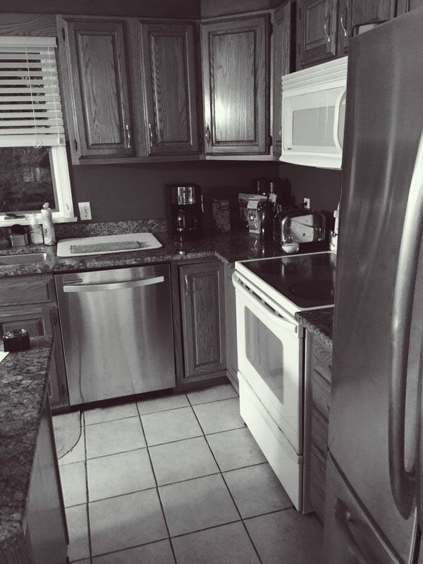 Before photo of a Mashpee kitchen with oak cabinets and tile flooring, part of a remodel by At Design Remodel