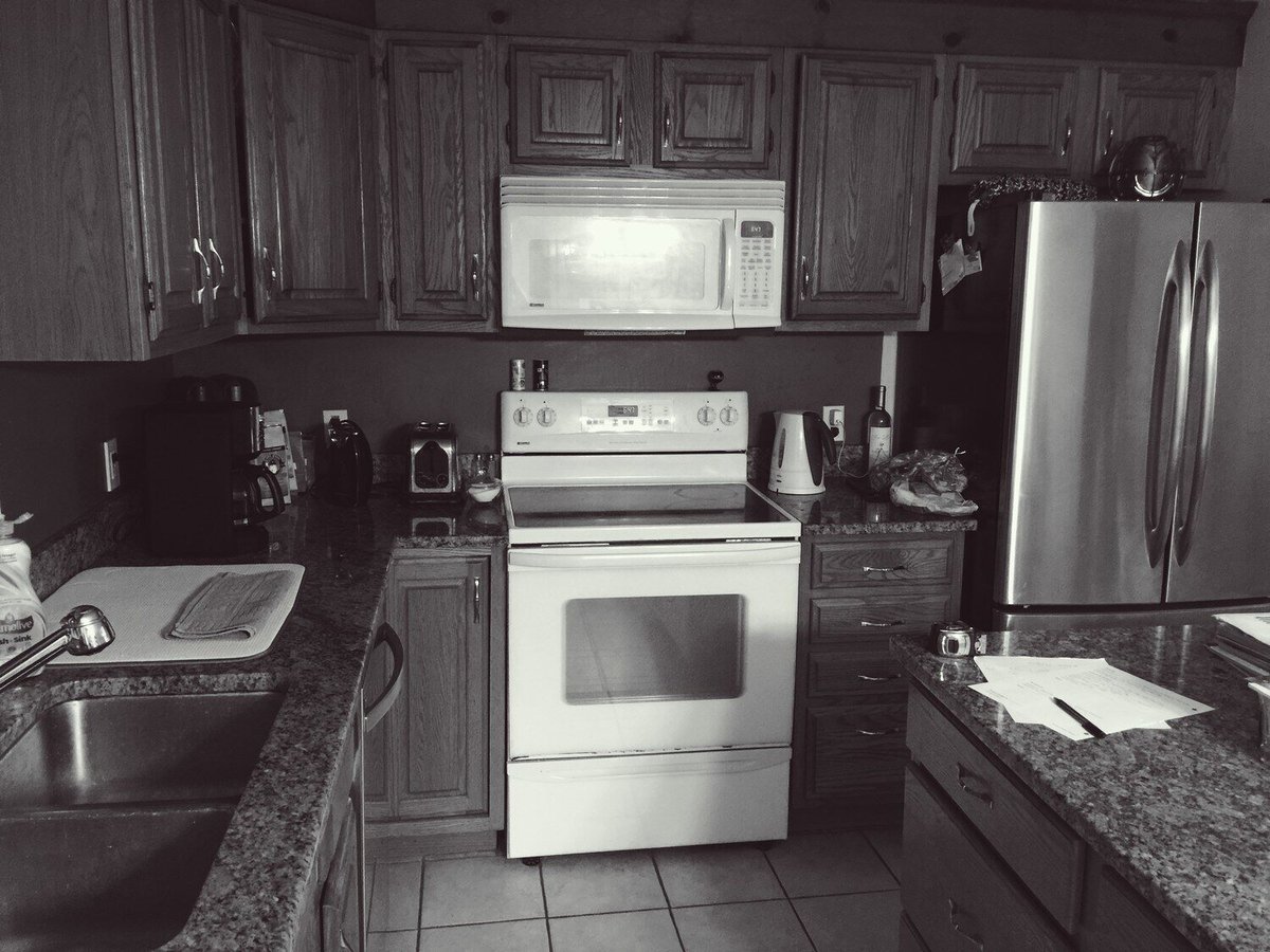 Mashpee kitchen with outdated oak cabinets and white appliances before renovation by At Design Remodel