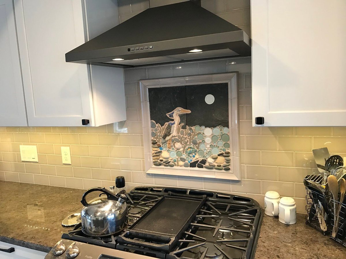 Granite kitchen countertop with stainless steel stove and custom backsplash, part of Mashpee remodel by At Design Remodel