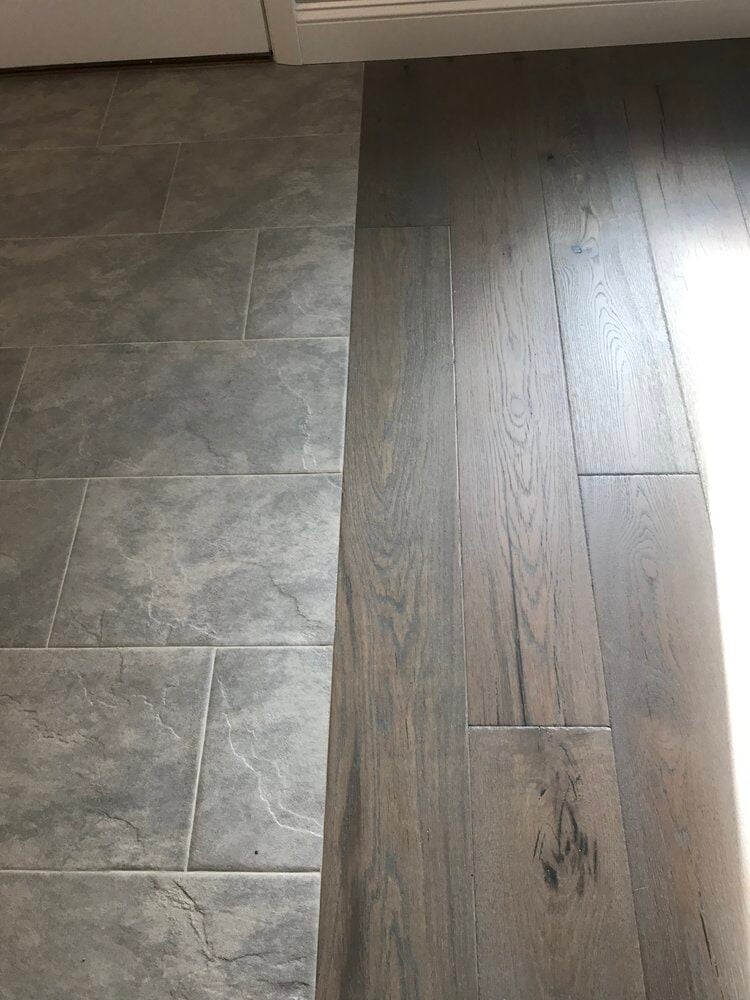 Seamless transition between tile and wood floors in kitchen remodel by At Design Remodel in Mashpee