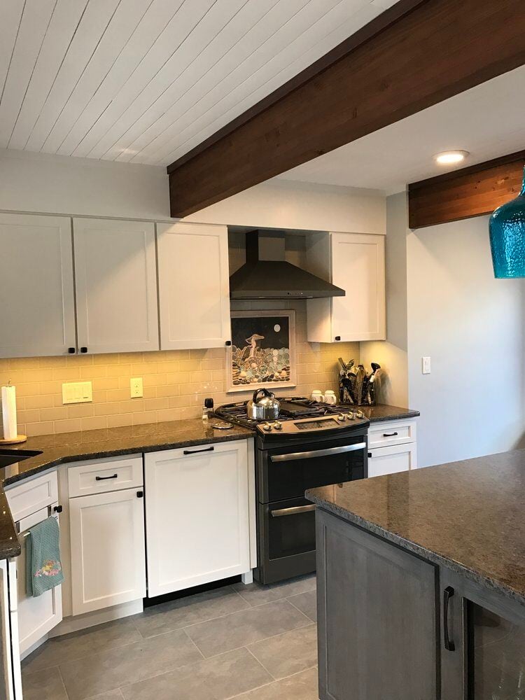 Updated kitchen with white cabinets and granite counters in Mashpee by At Design Remodel