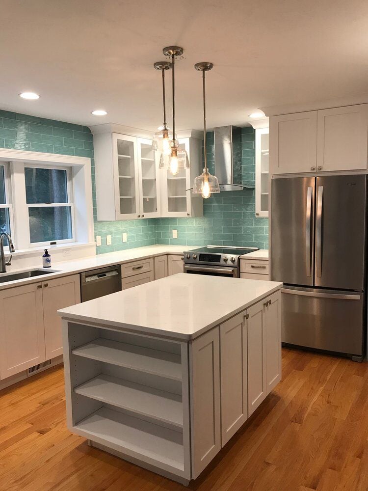 Custom kitchen renovation in Mashpee featuring a center island and teal backsplash, completed by At Design Remodel