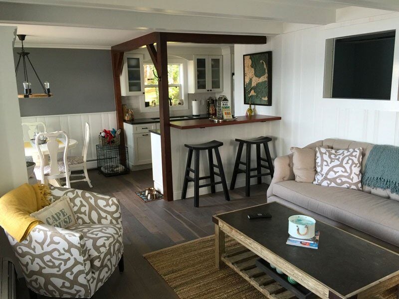 Cottage-style living room with a kitchen bar and coastal decor in a Mashpee home renovation