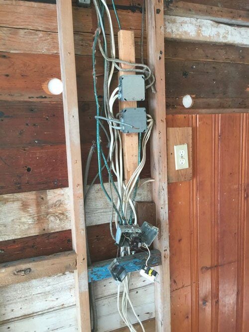 Exposed electrical wiring in the middle of a cottage renovation in Mashpee