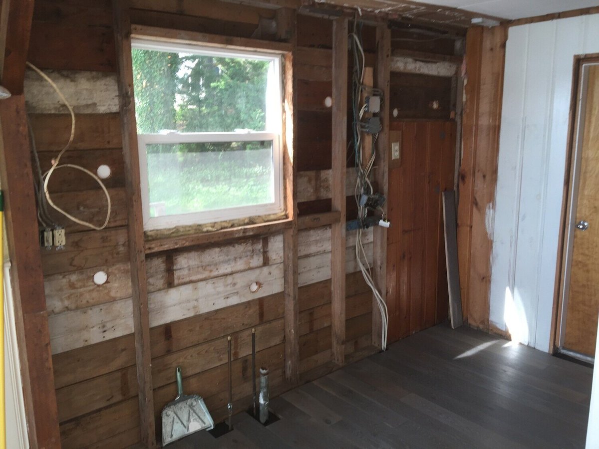 Mid-renovation shot of kitchen walls being reconstructed in a Mashpee lake cottage by At Design Remodel