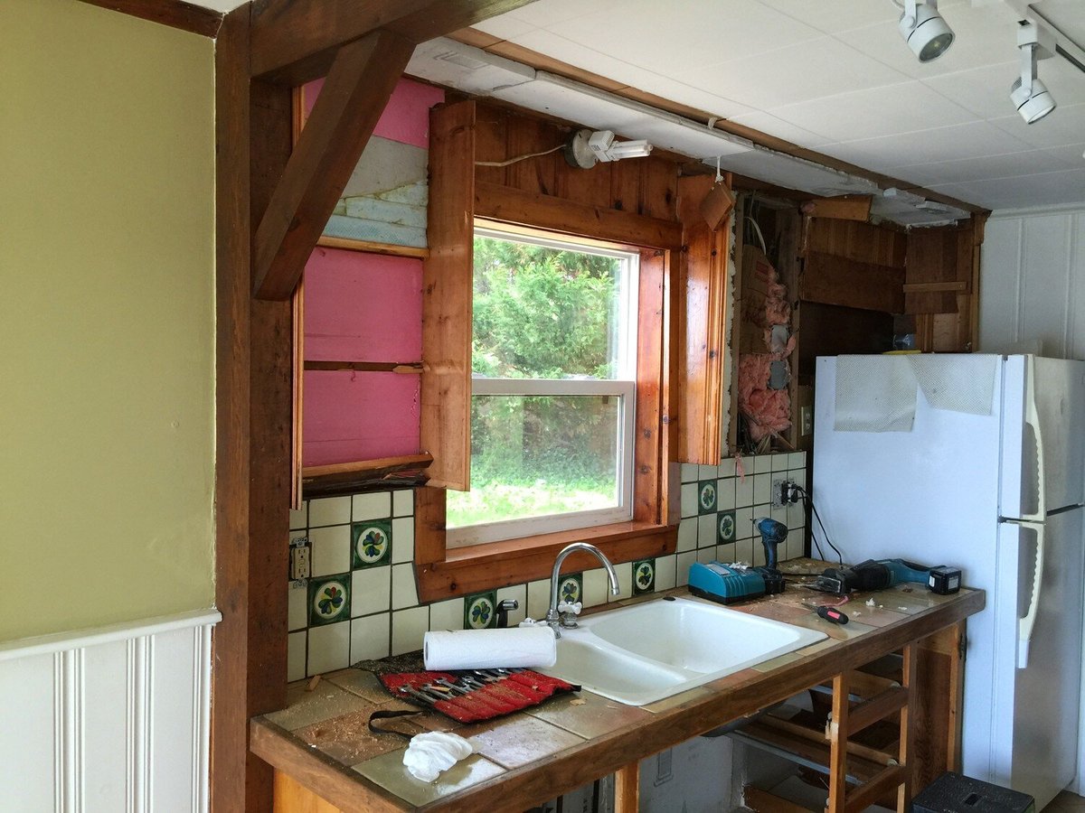 Ongoing kitchen remodel with exposed beams and window replacement, part of a Mashpee Lake Cottage renovation
