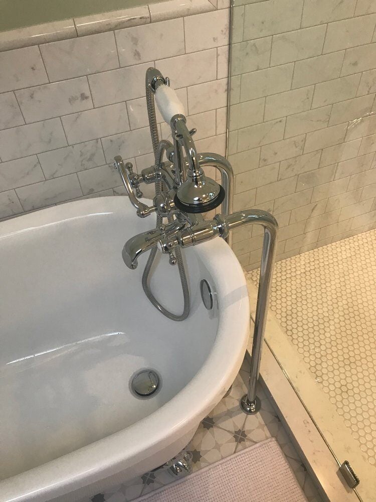 Beautiful clawfoot bathtub with vintage-style chrome faucet in a New Seabury remodel